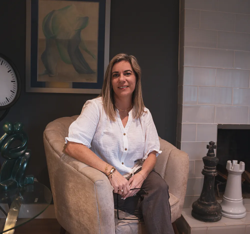 Alexandra Bayo seated in an armchair in her therapy office