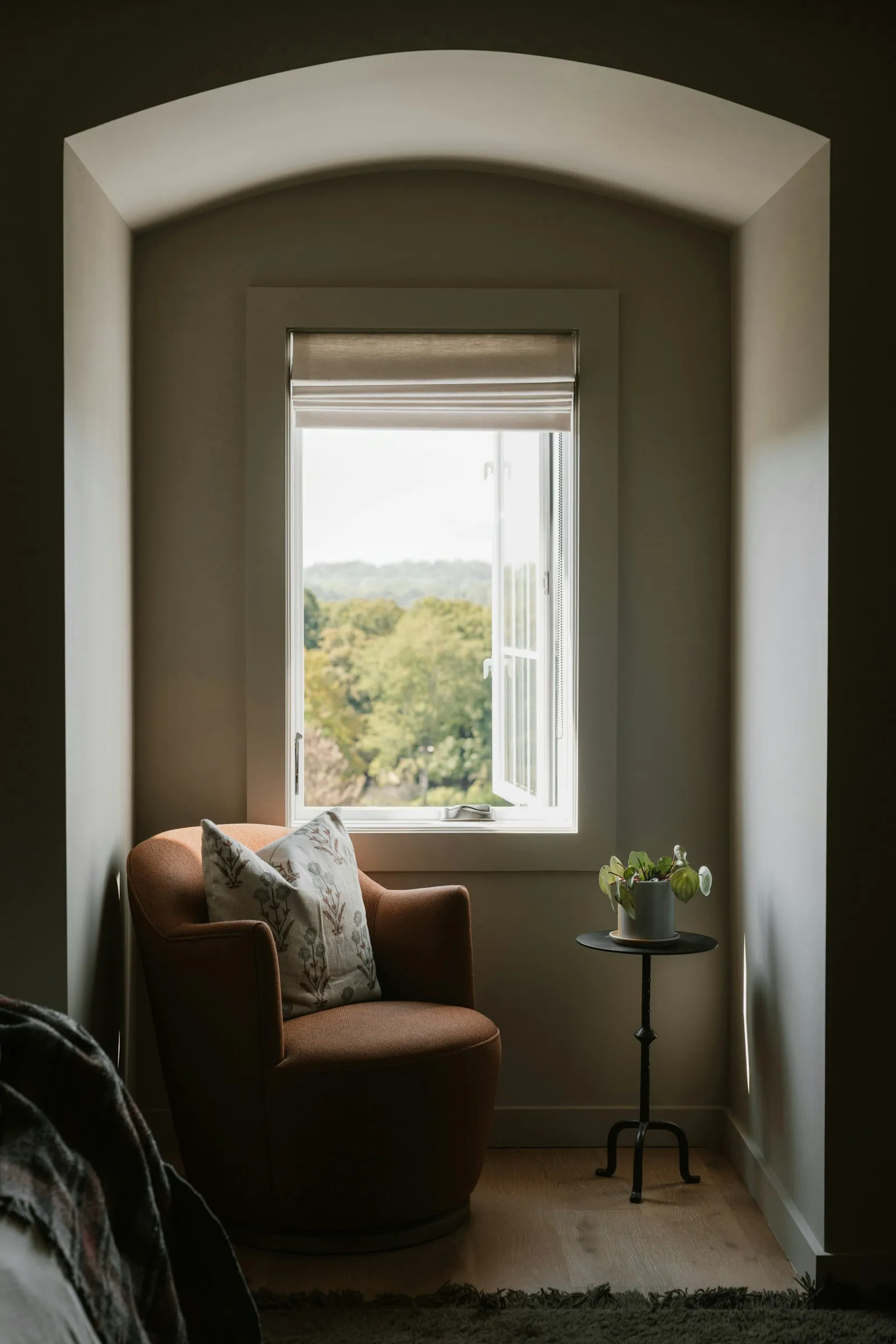 A calm, sunlit corner with a soft chair by a window